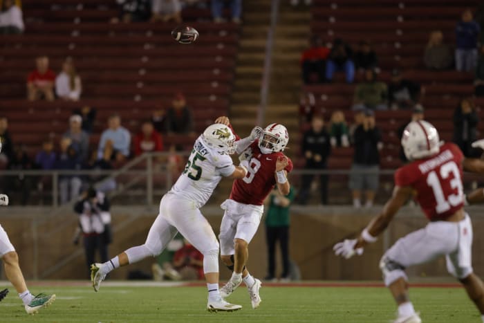 Sep 16, 2023; Stanford, California, USA; Stanford Cardinal quarterback Justin Lamson (8) is hit by Sacramento State Hornets defensive lineman Jett Stanley (55) during the fourth quarter at Stanford Stadium. Mandatory Credit: Sergio Estrada-USA TODAY Sports